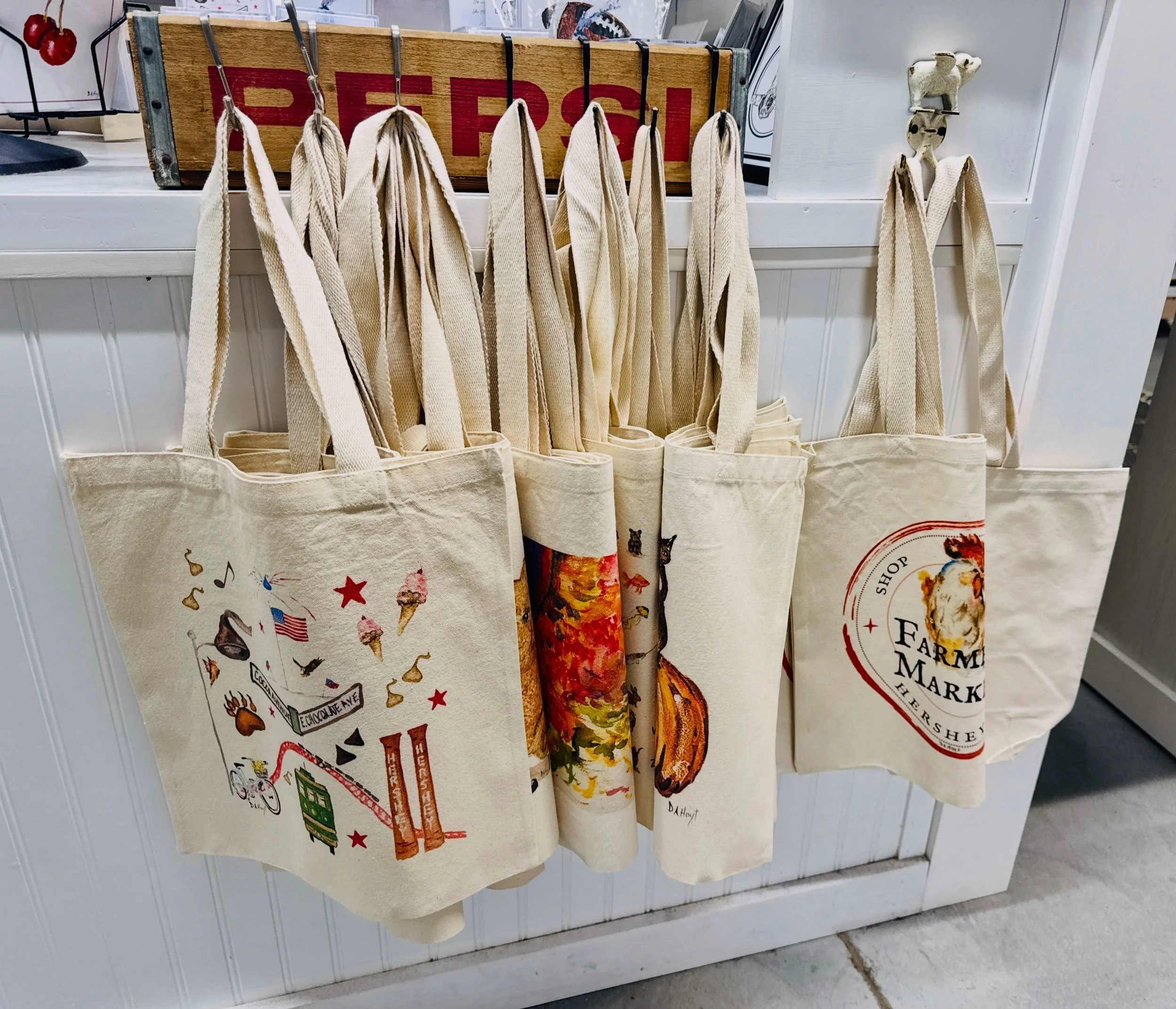 Handpainted with love, made for everyday use 🎨 Stop in and pick up a reusable tote from our favorite local artist at @lindenbrookshoppe 🤍 Perfect for market day and every day after! Visit the market today to grab one or gift one 🛍️ #freshmarkether
