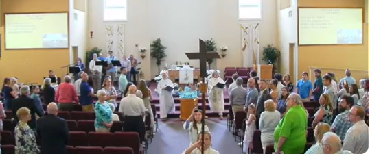 Image of Pastor Kim and Vicar Kirstin, as well as crucifer & acolyte recessing after Easter 2026 service