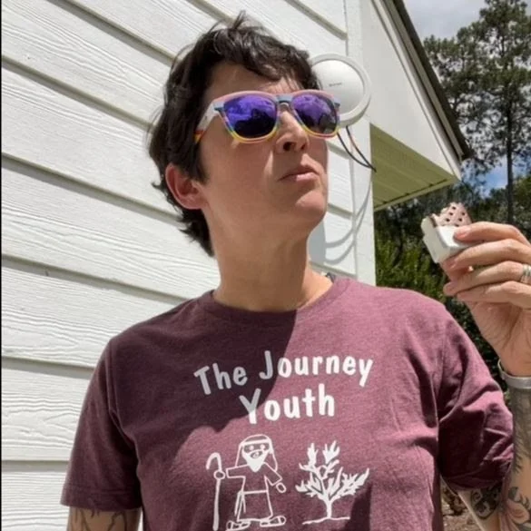 Picture of Pastor Emily looking stylish in a Journey Youth T-shirt and trendy shades while eating an ice cream sandwich.