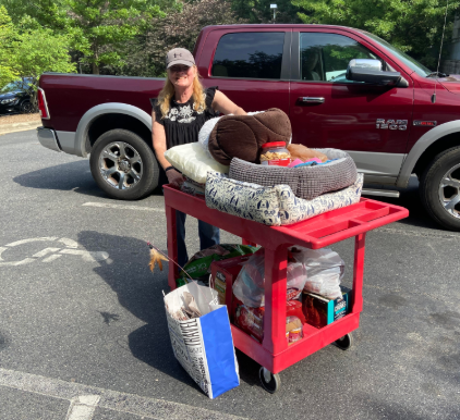 photo of Laura dropping off pet donations at the animal shelter