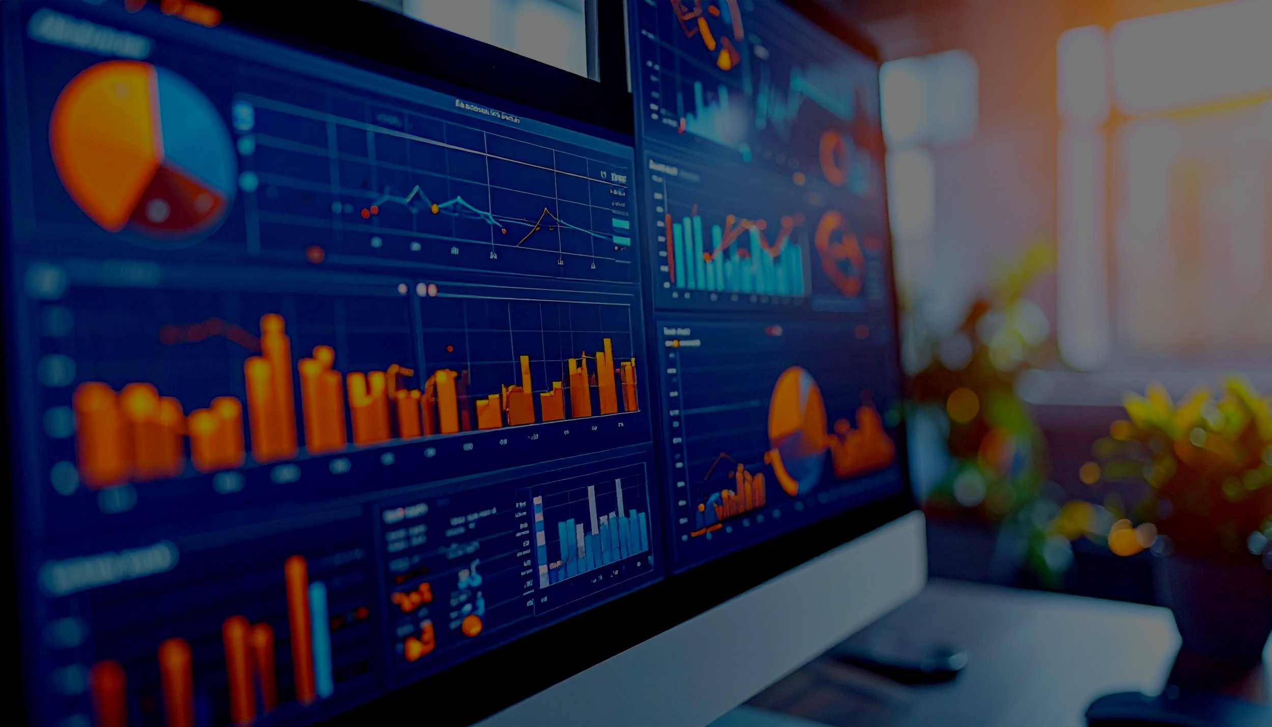 Computer monitor displaying various colorful financial graphs and charts