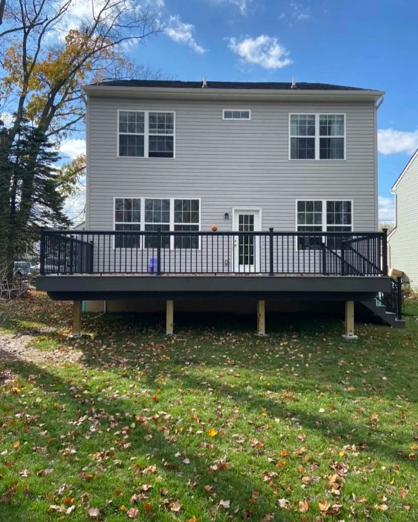 After - TimberTech Composite decking with complementary fascia on rim and beam with black aluminum 2.5'' handrail system with solar light caps