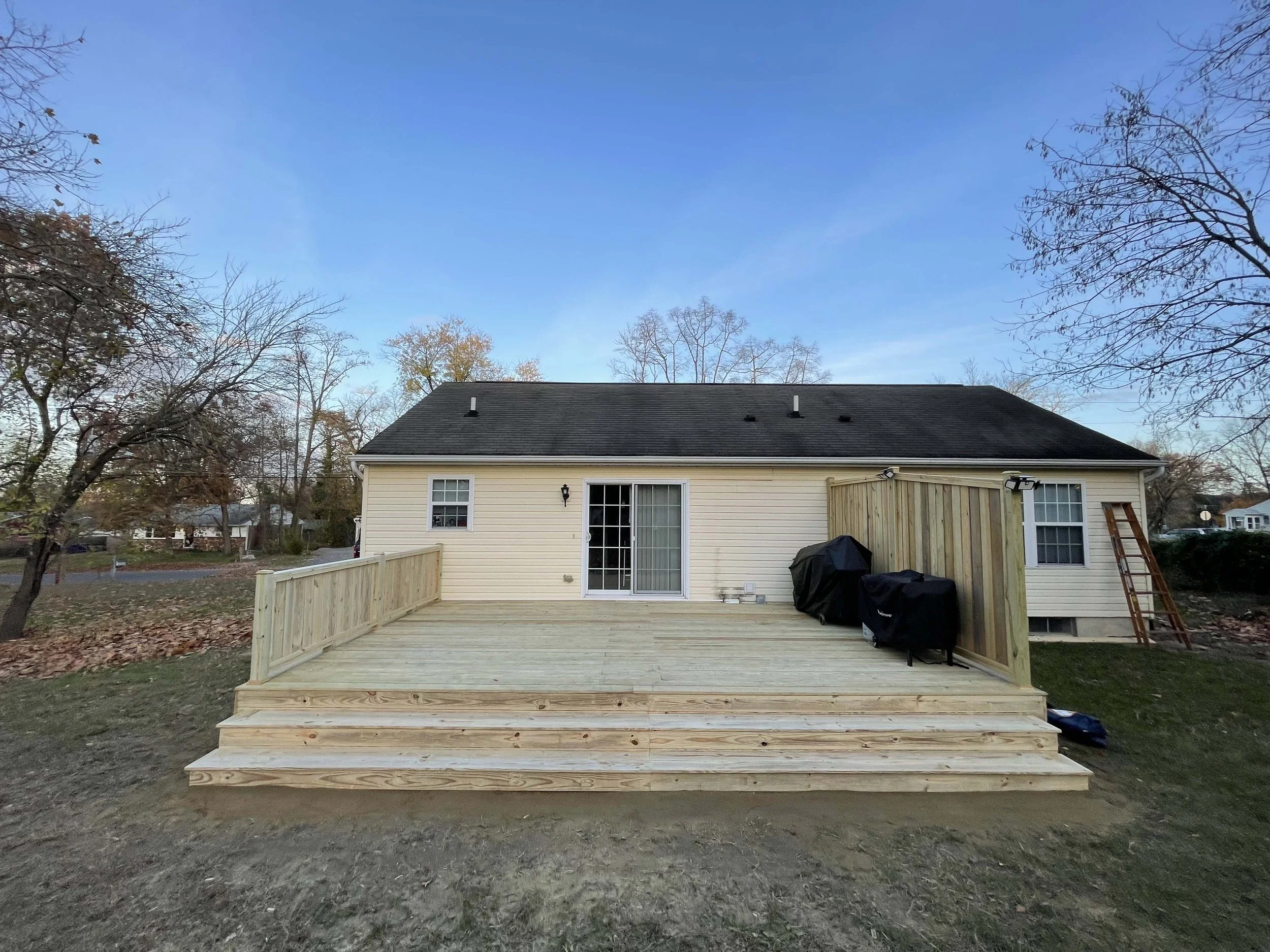 After - New pressure treated deck, waterfall stairs and hand crafted privacy fence and railing