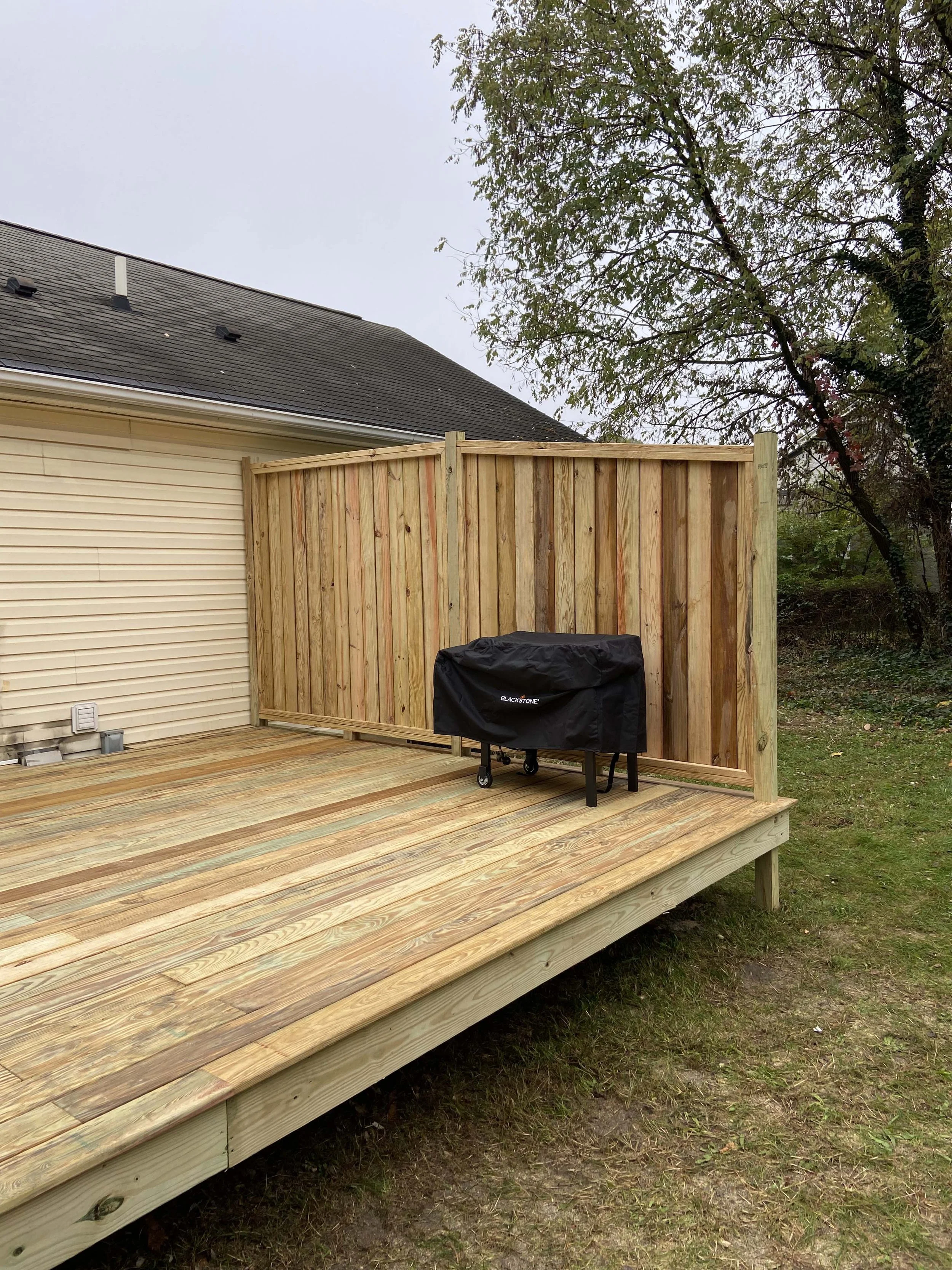 After - New pressure treated deck, waterfall stairs and hand crafted privacy fence and railing