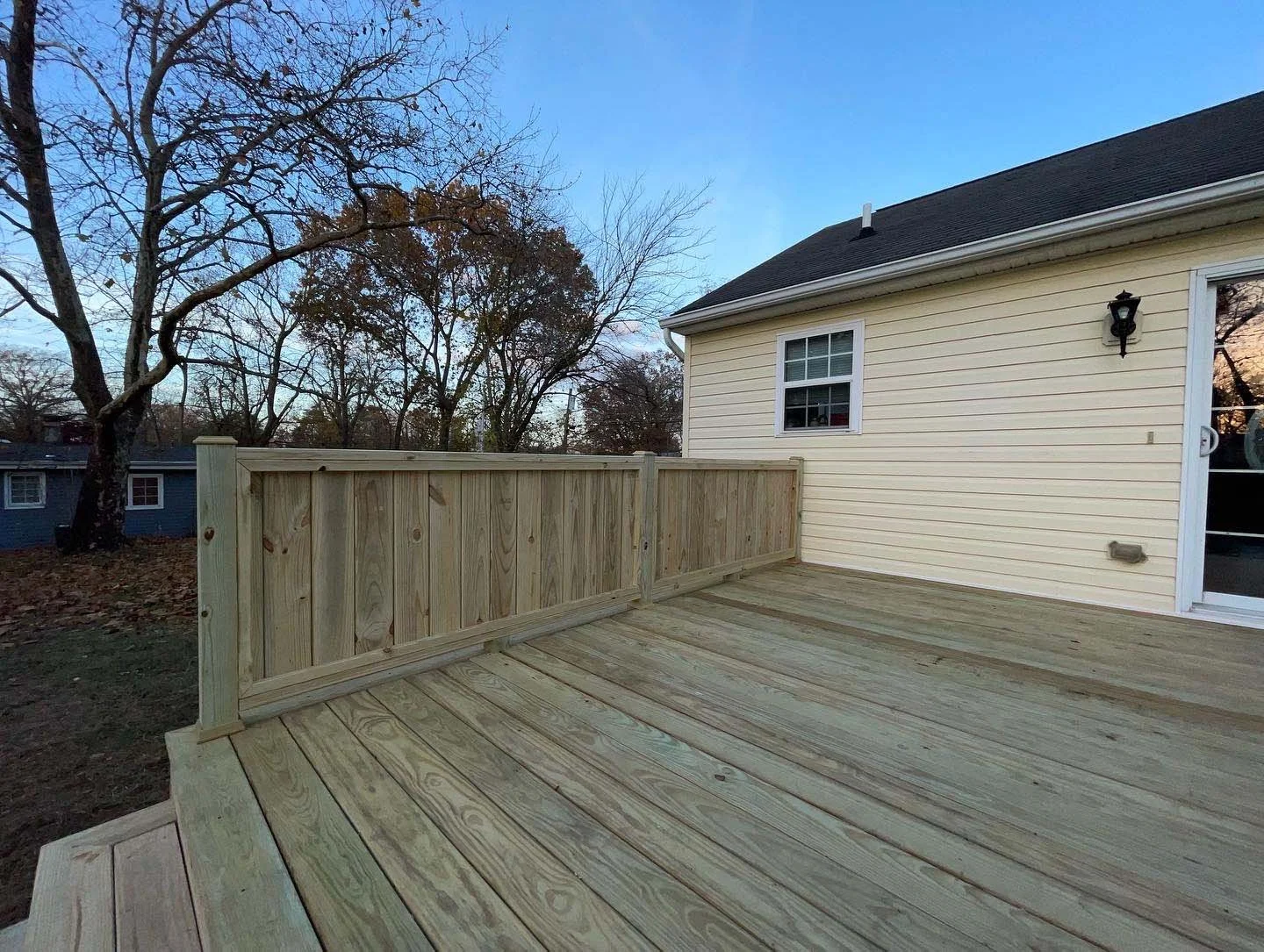 After - New pressure treated deck, waterfall stairs and hand crafted privacy fence and railing