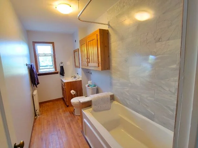 Bathroom renovation with marbled tile shower.