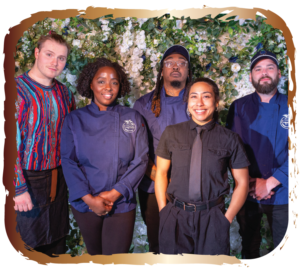 Group of five diverse chefs and kitchen staff standing in front of a floral backdrop.
