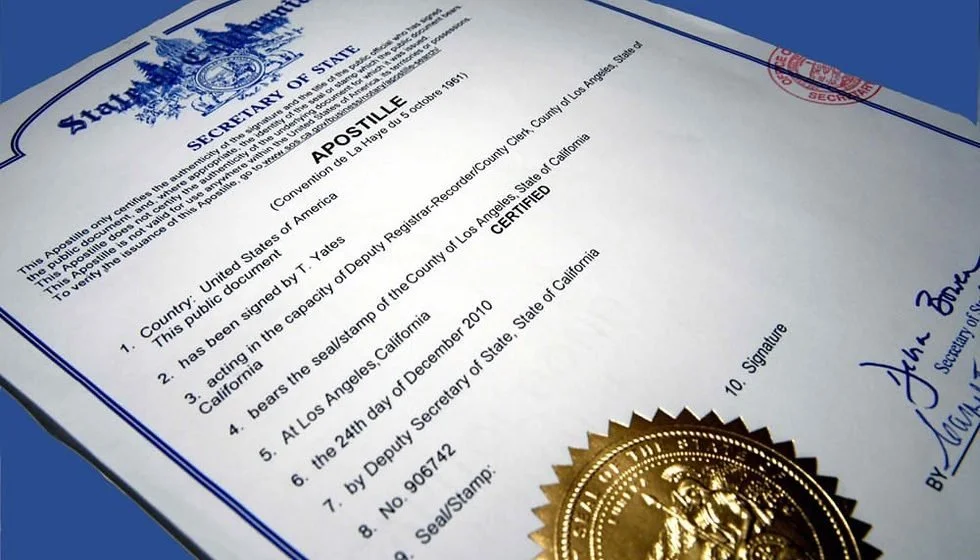 Certificate of apostille with a gold seal on bottom right, signed by Deputy Secretary of State, on a blue background.