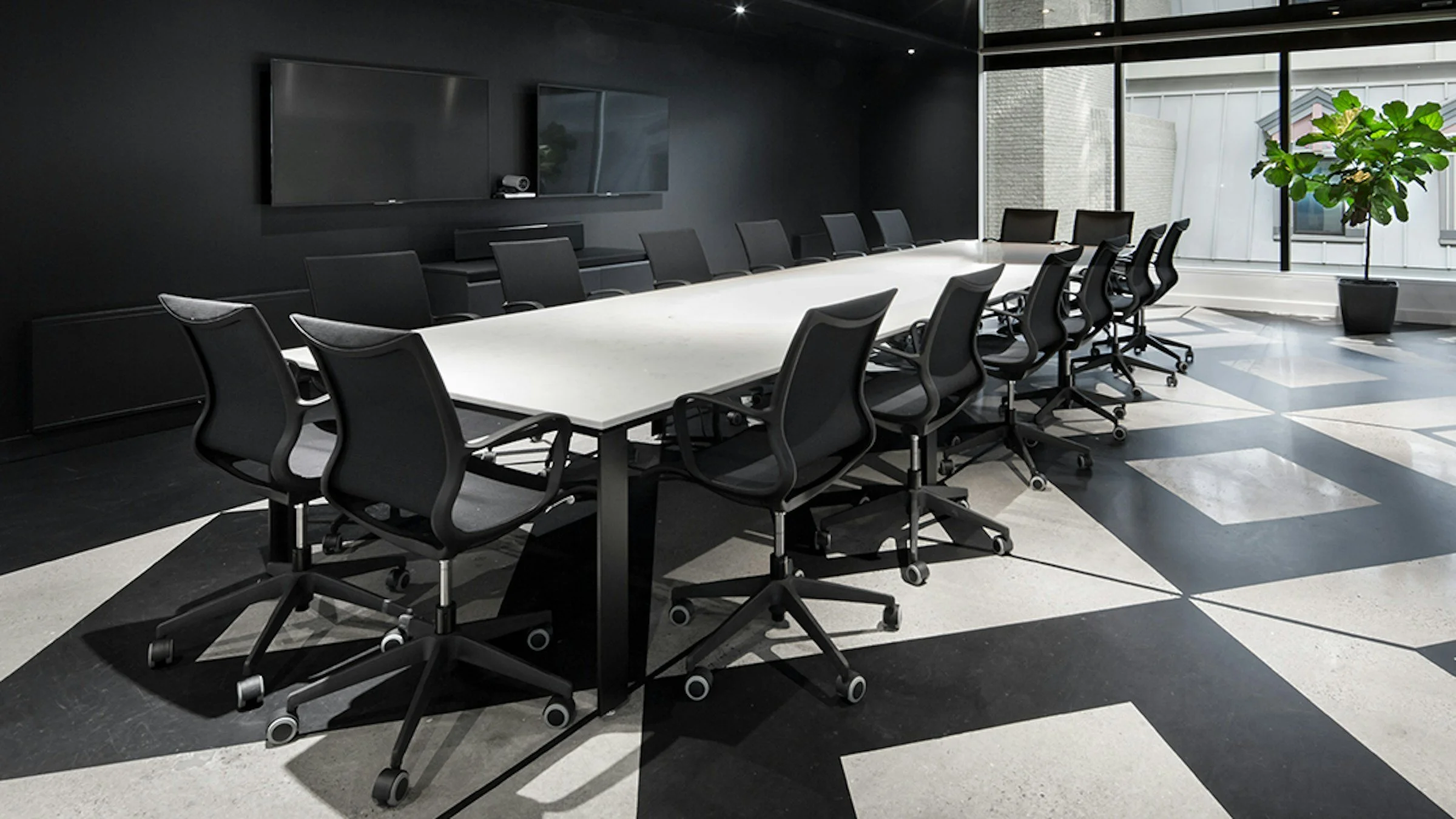 Solar chairs in a black conference room with white table