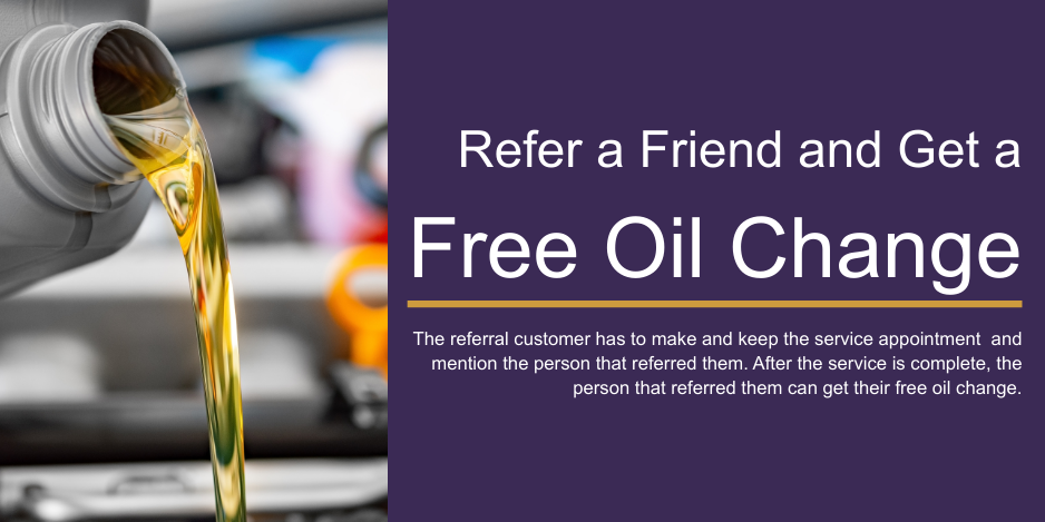 Oil being poured from a container with a purple promotional sign for a free oil change offer.