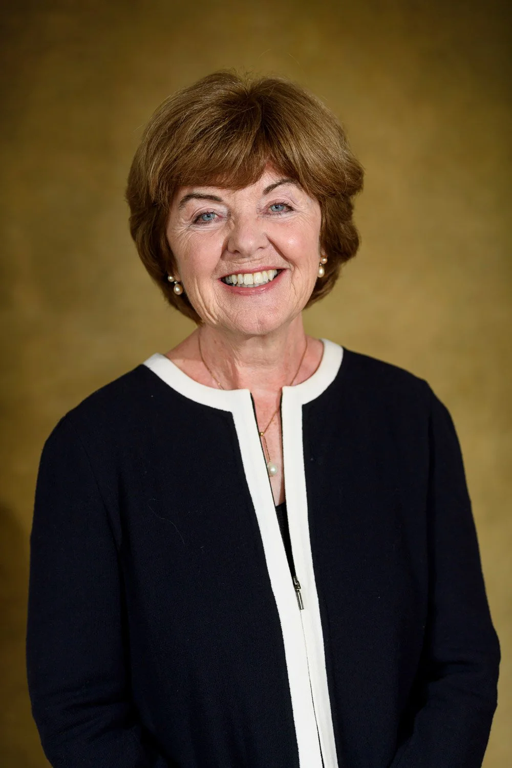 Relaxed professional headshot of a person in a smart-casual sweater.