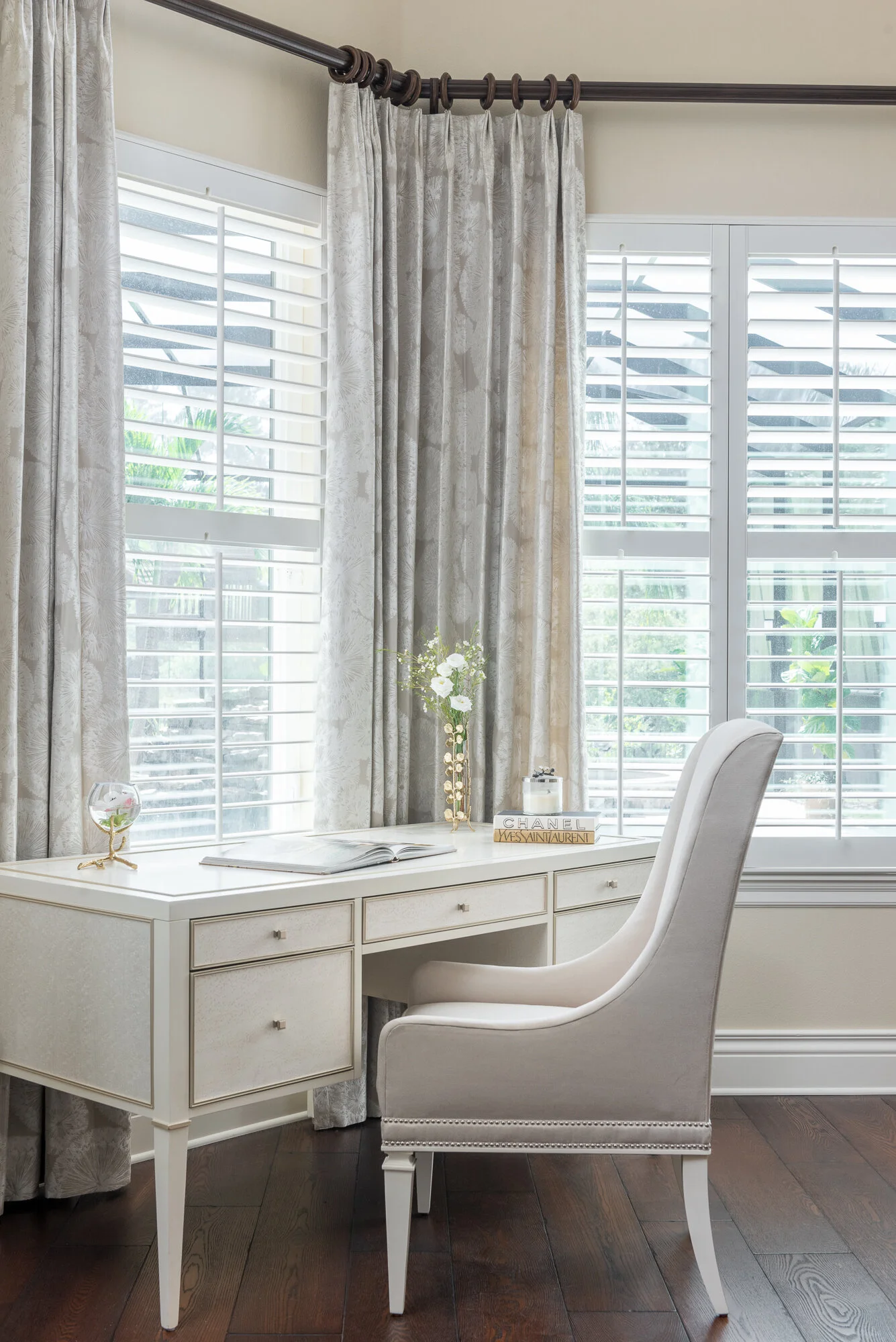White wood desk and chair with grey off white window treatment