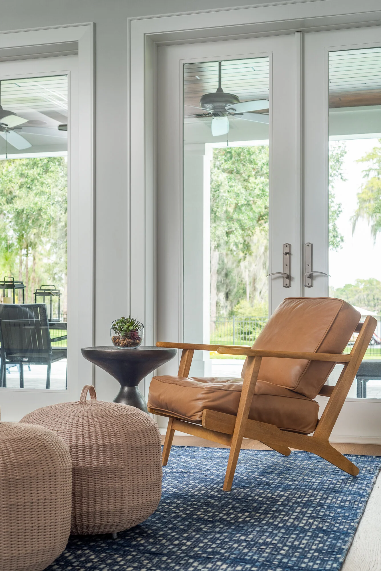 wood and leather armchair blue rug in living room