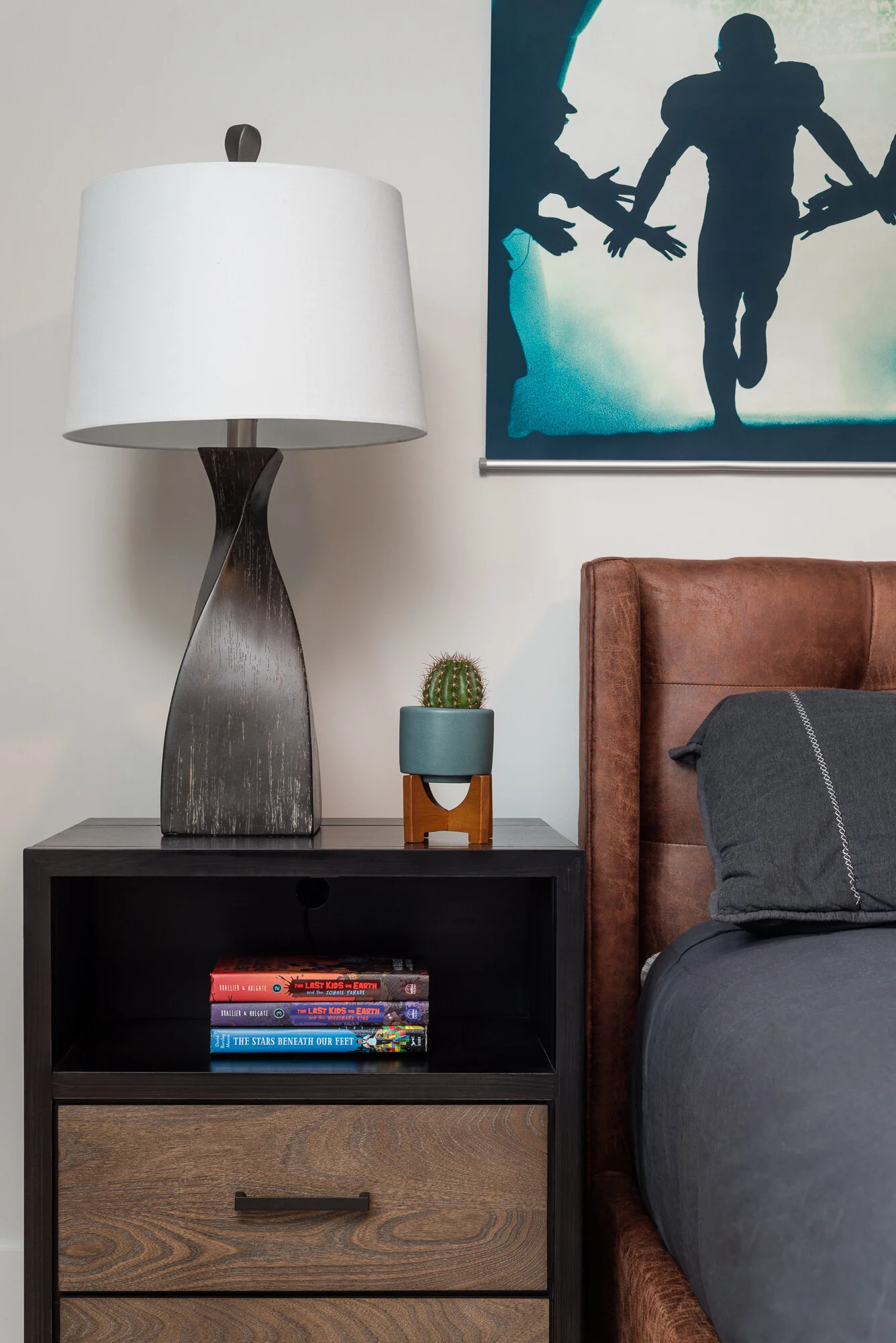 Dark bedside table modern lamp and blue comforter