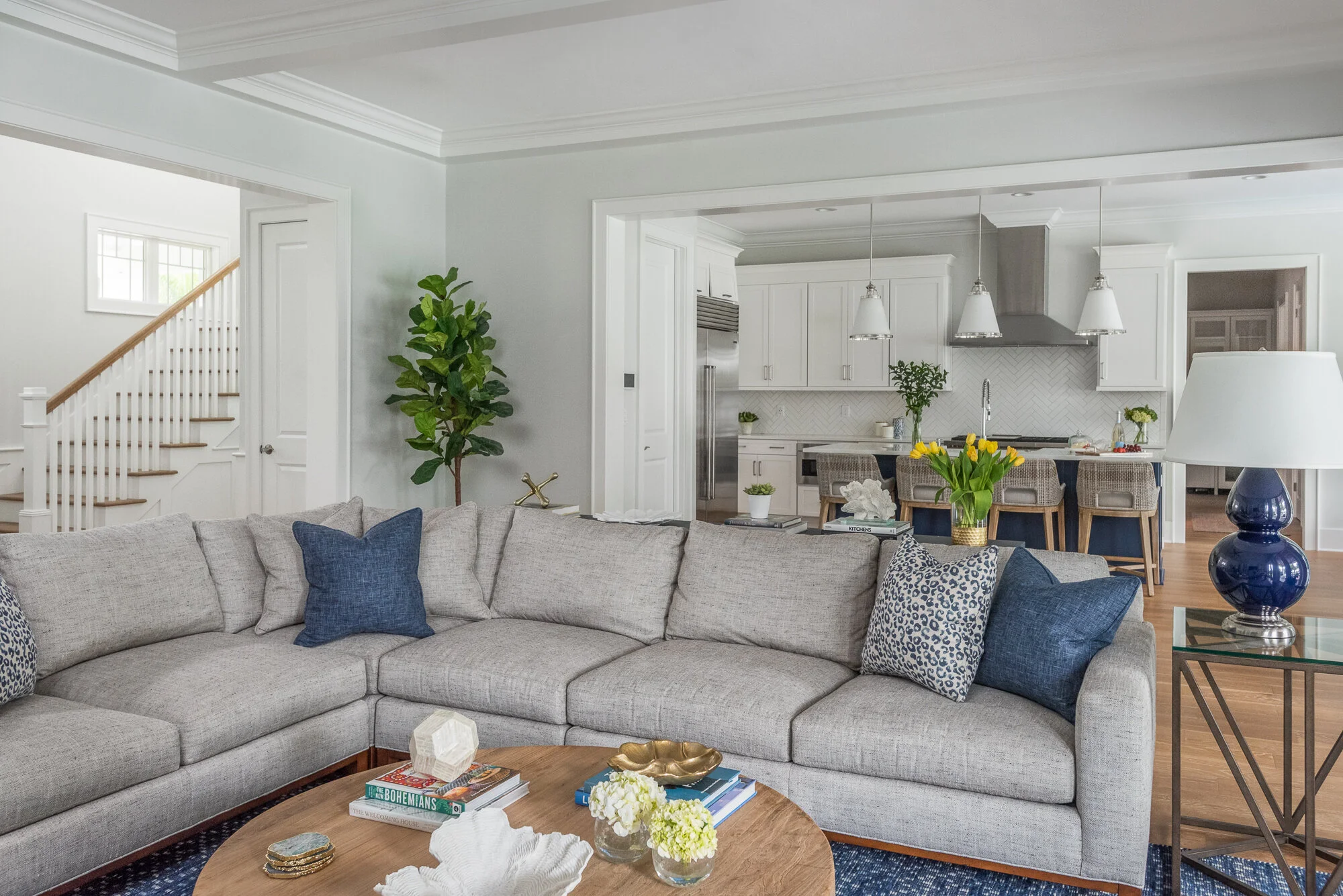 Grey couch, wood coffee table, blue pillow and lamp accents