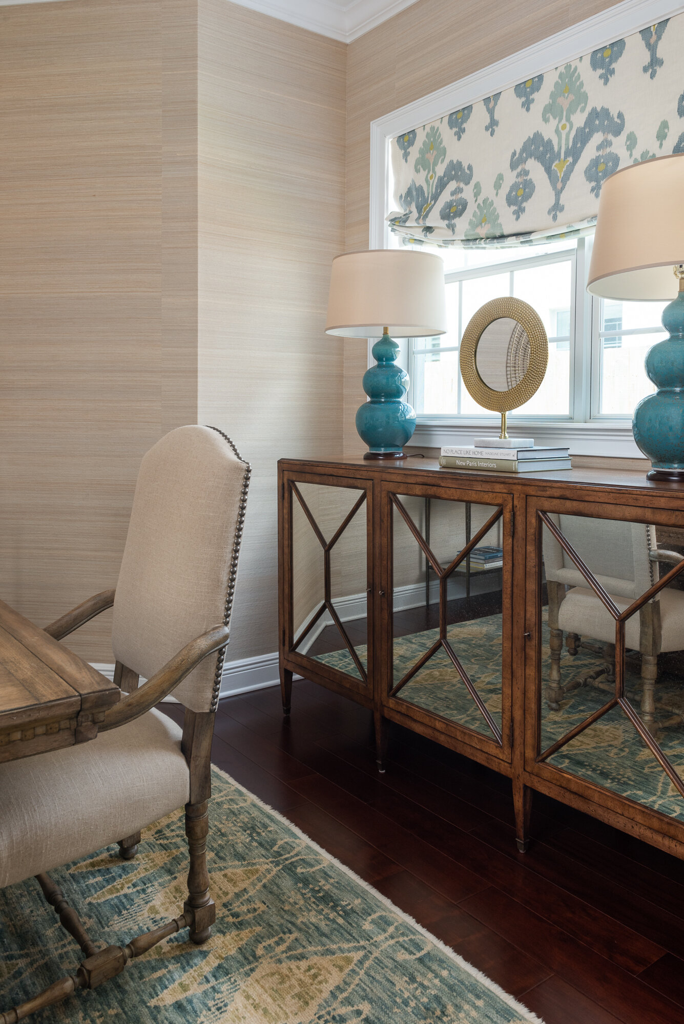 Dining room blue lampstand and wood mirrored sideboard
