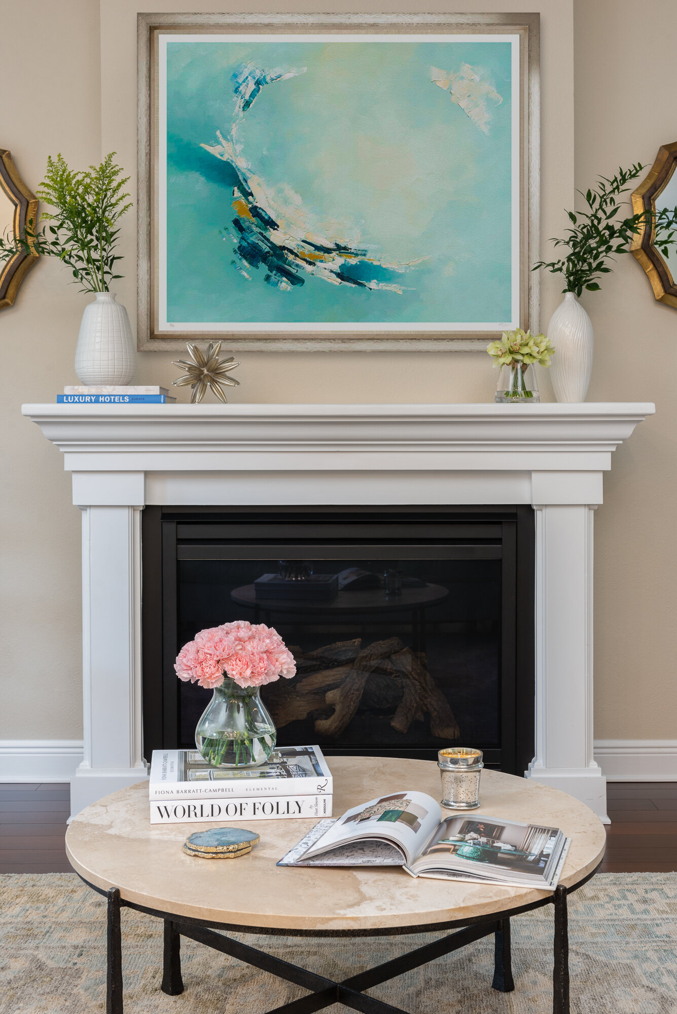 Traditional warm living room with fire place and blue painting