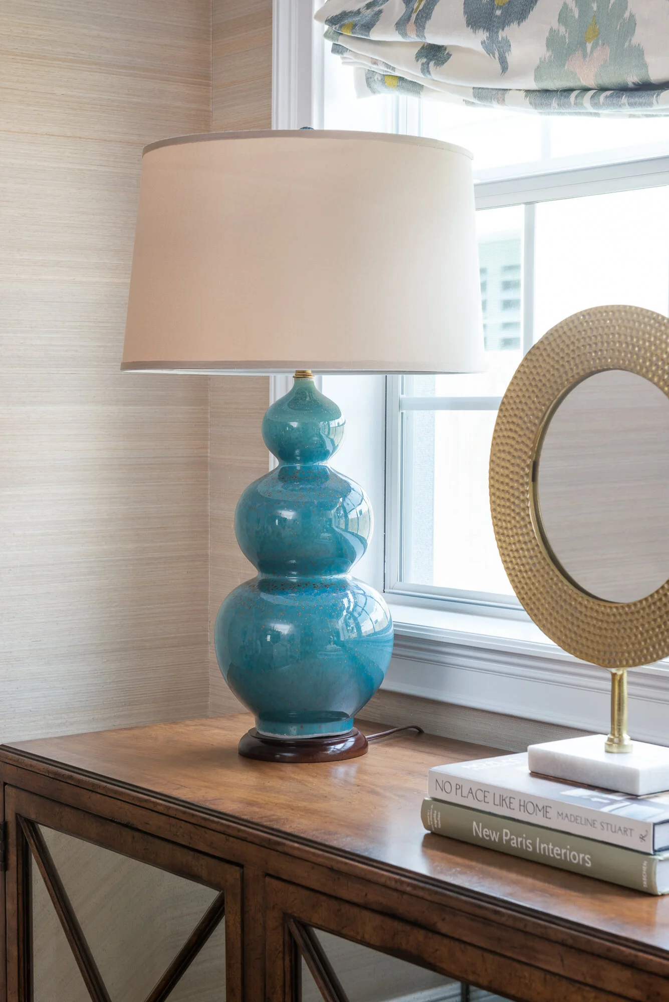 Dining room blue lampstand and wood mirrored sideboard