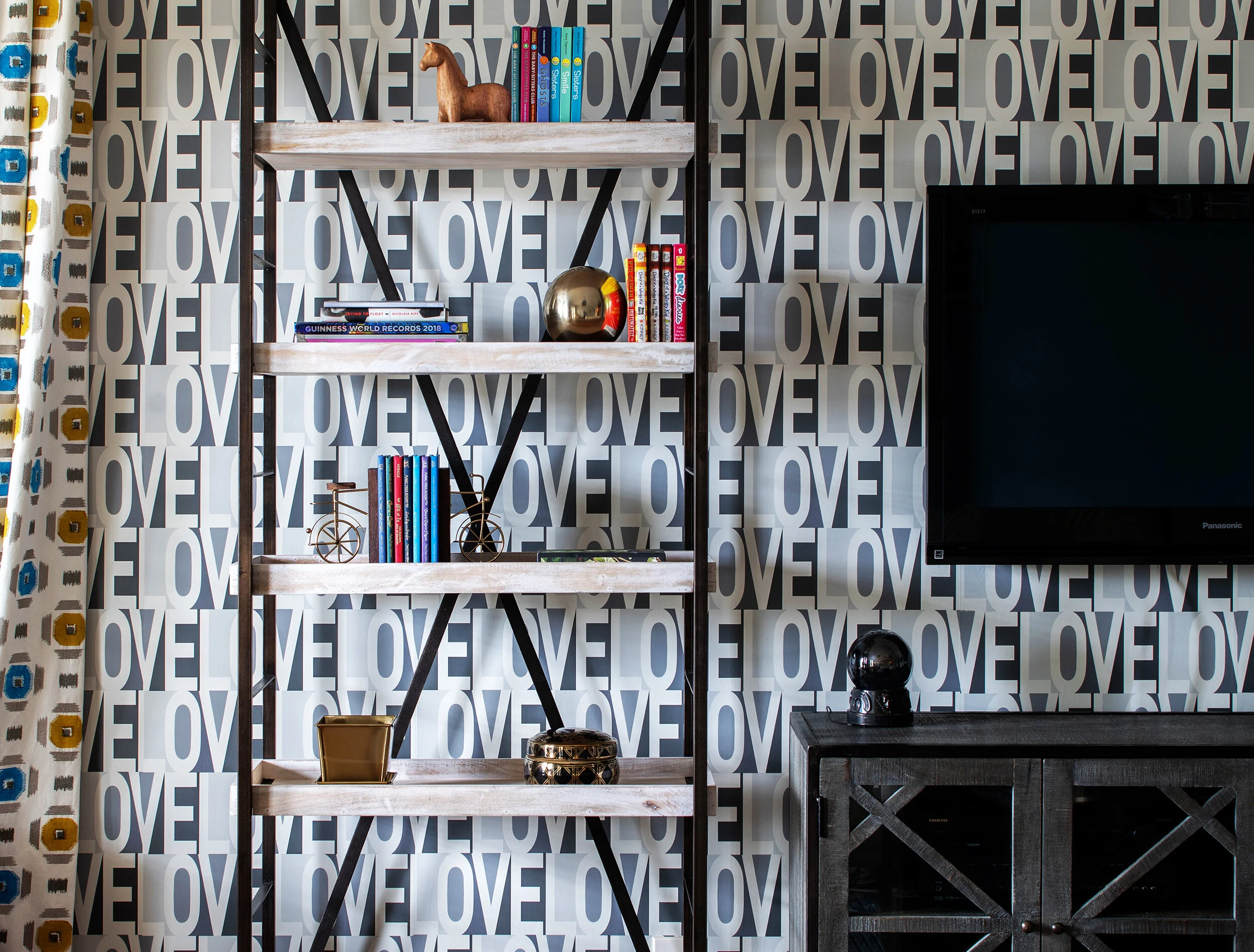 Blue lettering wallpaper and shelves