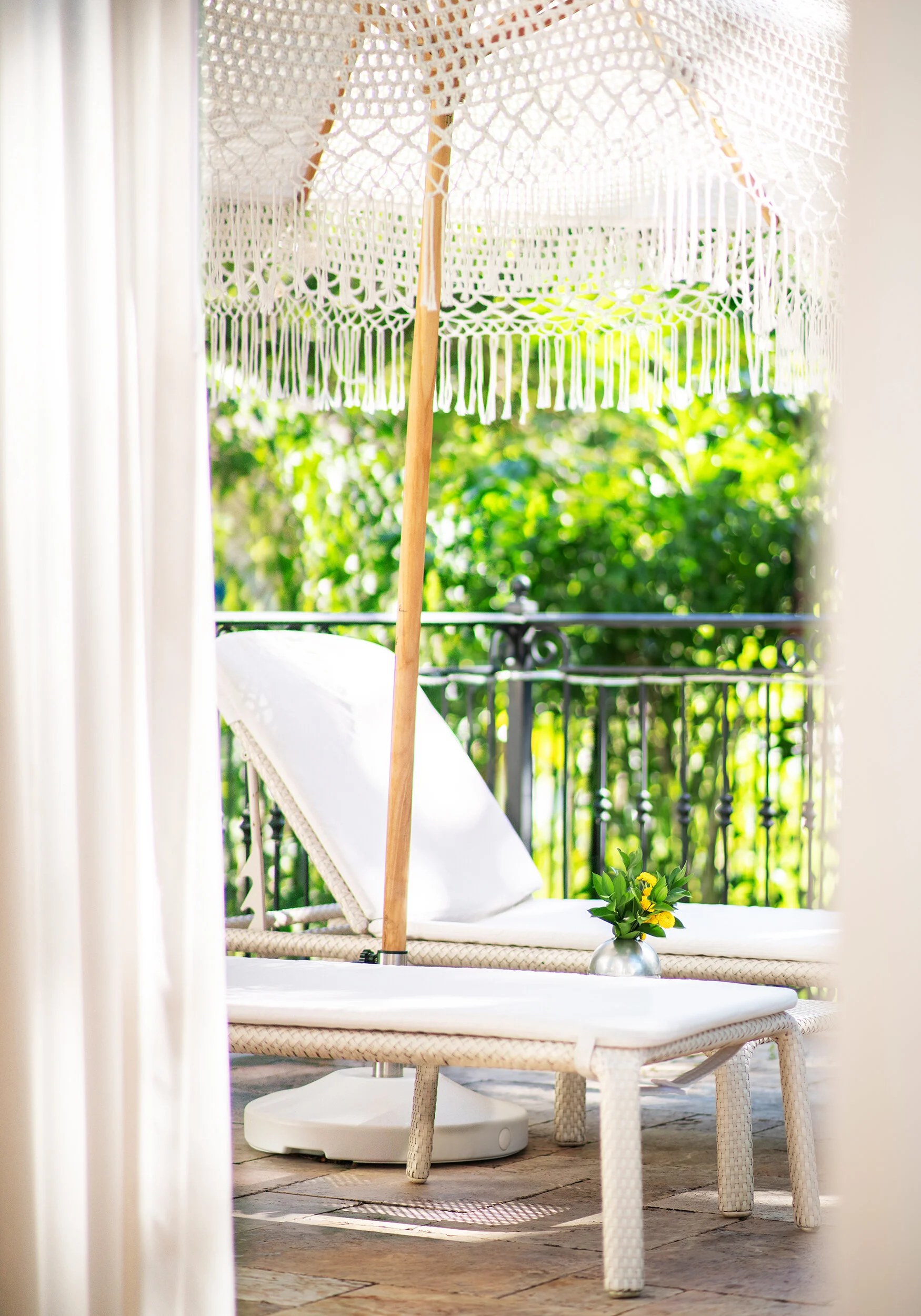 White lounge chair crocheted umbrella