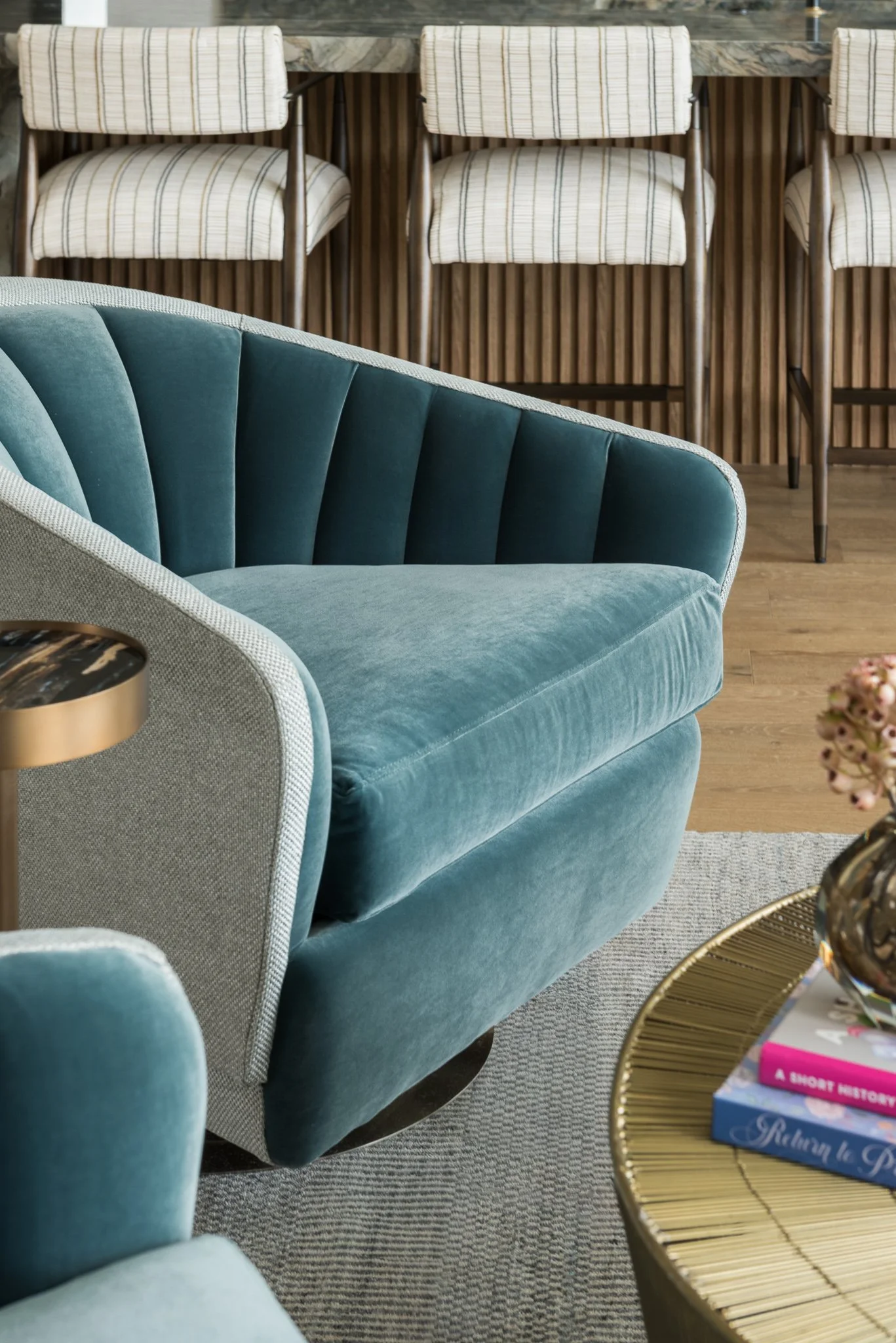  Teal channel-tufted velvet chair near a home bar 
