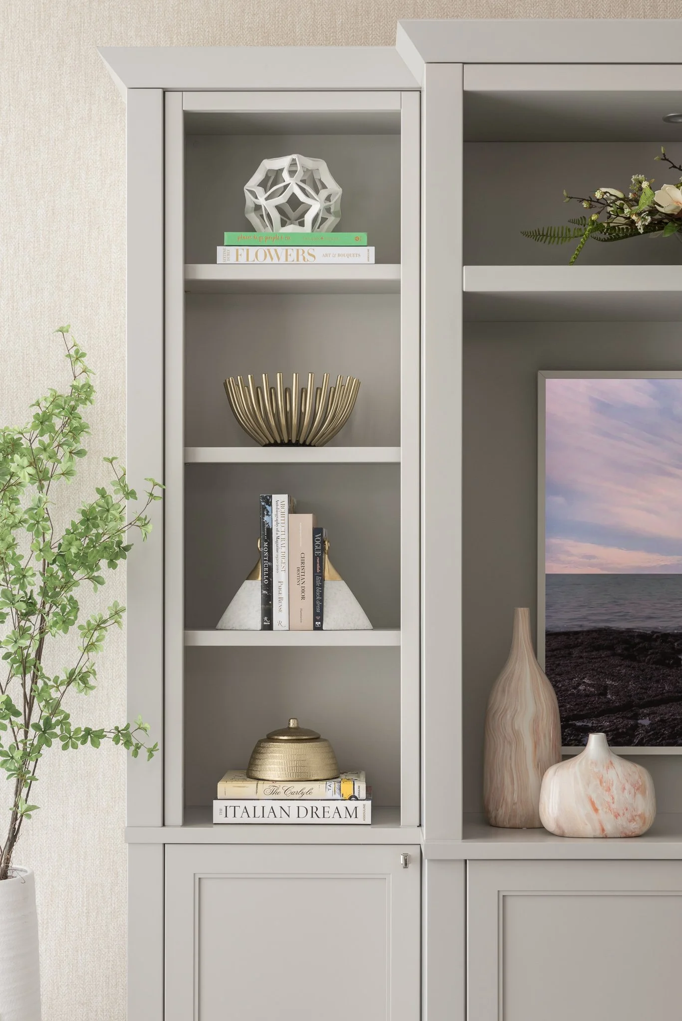 Decorative shelves with books, vases, and artistic objects in a modern living room.
