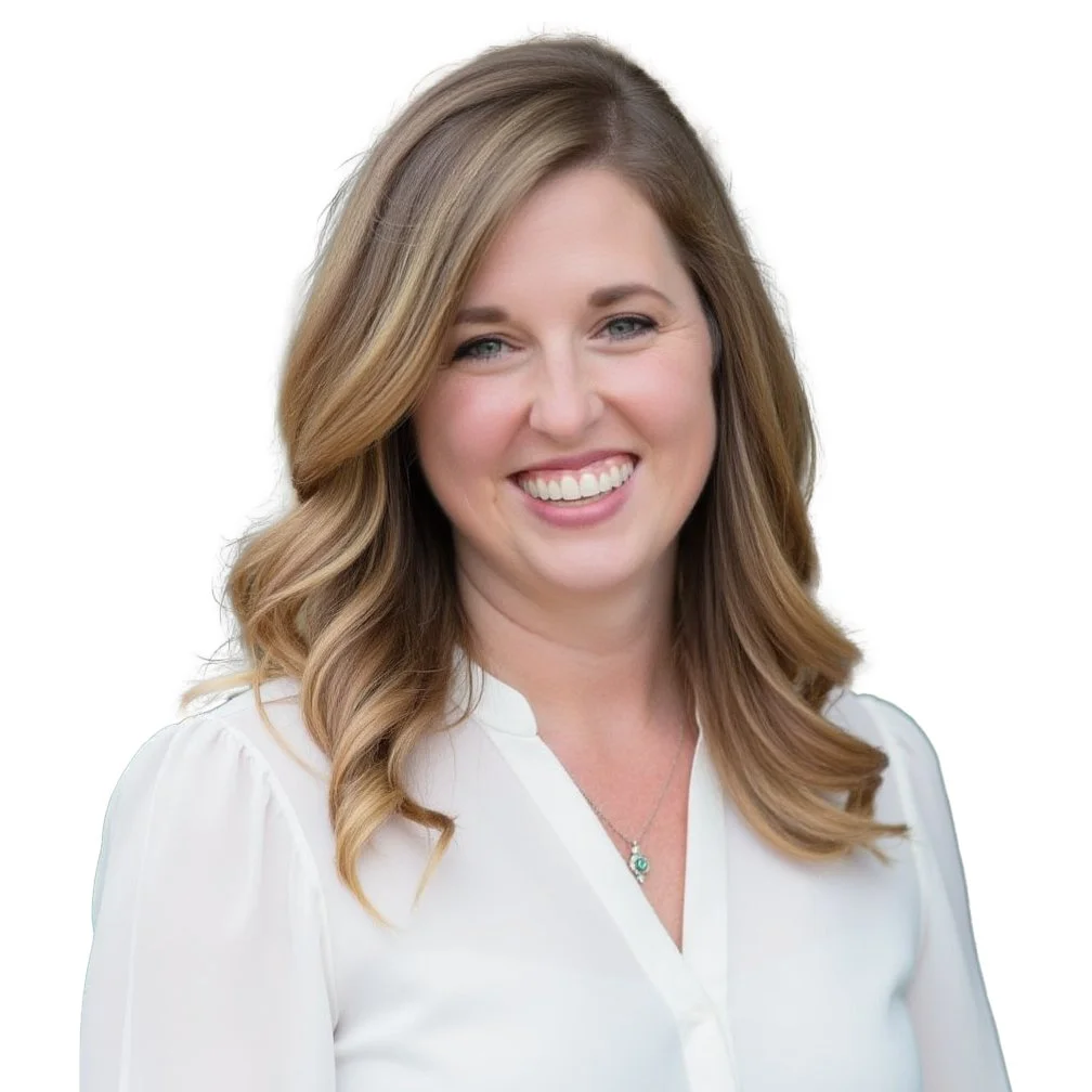 Portrait of a smiling woman with shoulder-length wavy blonde hair, wearing a white blouse and a necklace, against a white background.