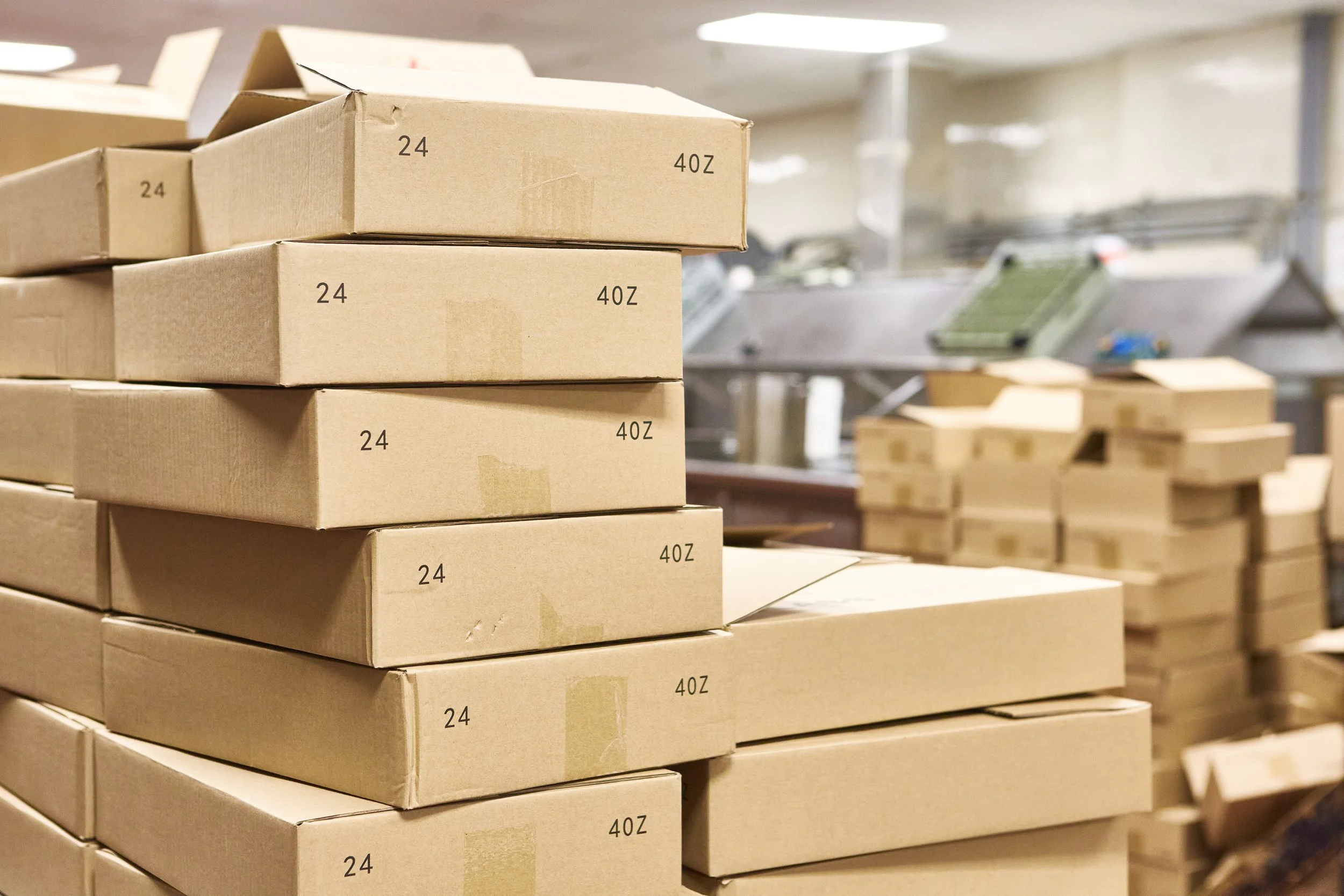 Stack of cardboard boxes in a warehouse or storage area.