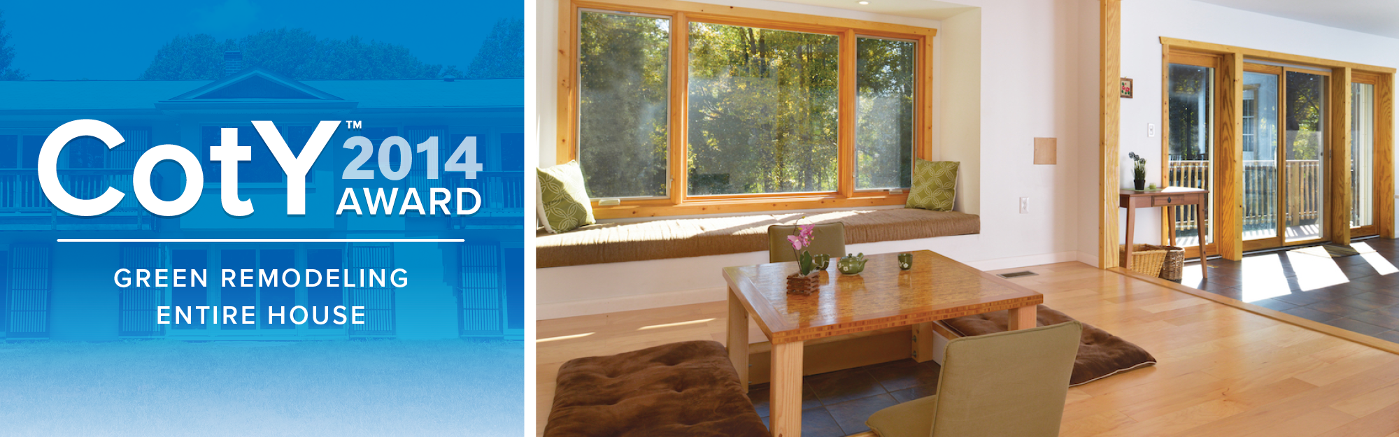 Living room with large window seat, wooden window trim, sliding glass door to a balcony, and natural wood accents.