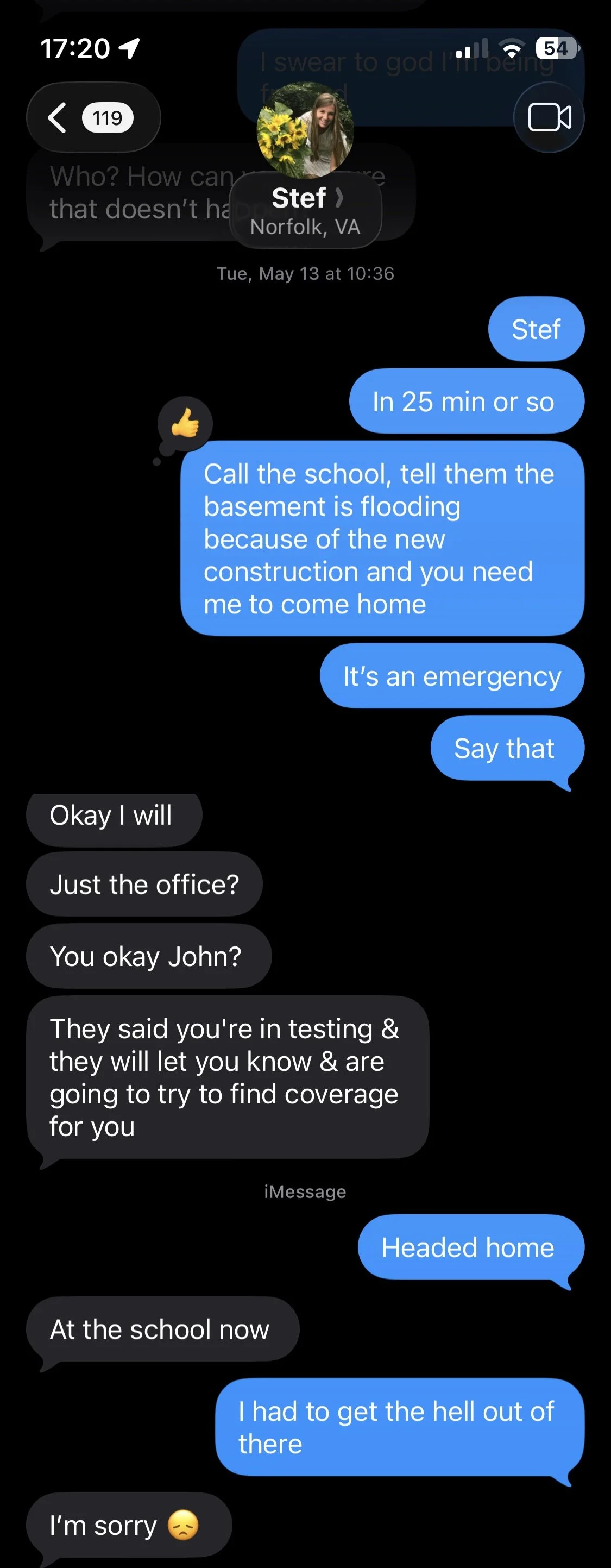 Text message conversation on a phone screen about flooding in a basement due to construction, with messages about calling the school, emergency, and heading home.