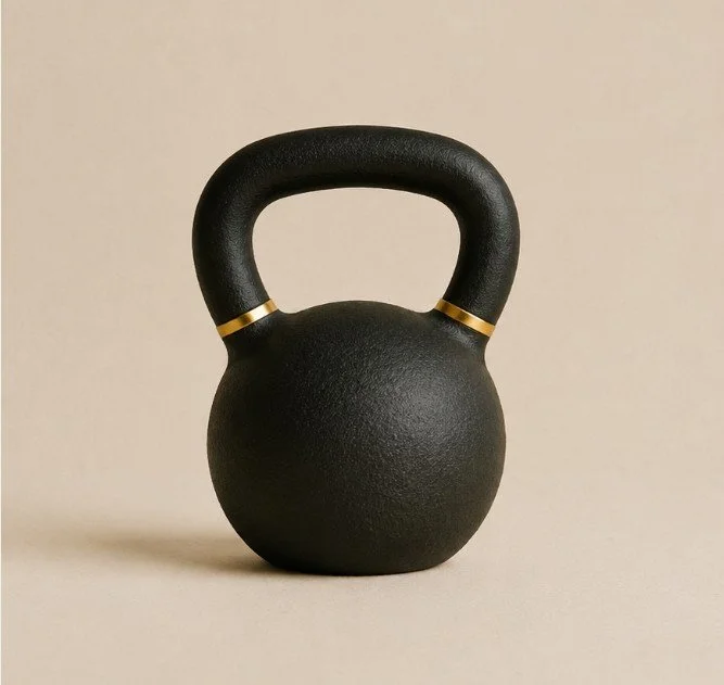 A black kettlebell with gold accents on a beige background.