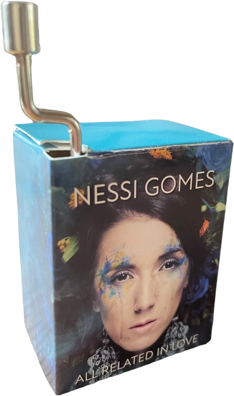 Close-up of a blue book cover with a woman's face and the text "Nessi Gomes" and "All Related in Love."