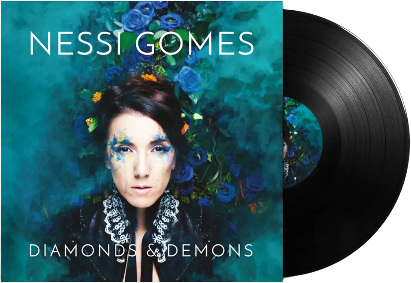Album cover of Nessi Gomes titled Diamonds & Demons, featuring a woman with dark hair, blue and yellow face paint, and a black lace collar, surrounded by blue roses and green foliage.