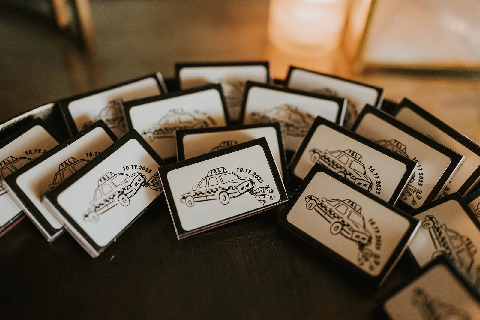 A collection of matchboxes featuring a design of a police car with the text '10.17.2025' and a small label reading 'M.T.W.'.