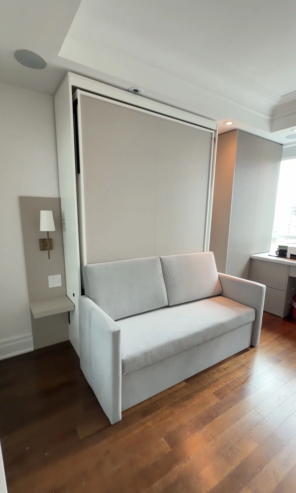 Motorized Queen sized hidden-bed with sofa @ Toronto Downtown The Avenue: Light colour finish sofa, painted back panel to match with newly added wall panel