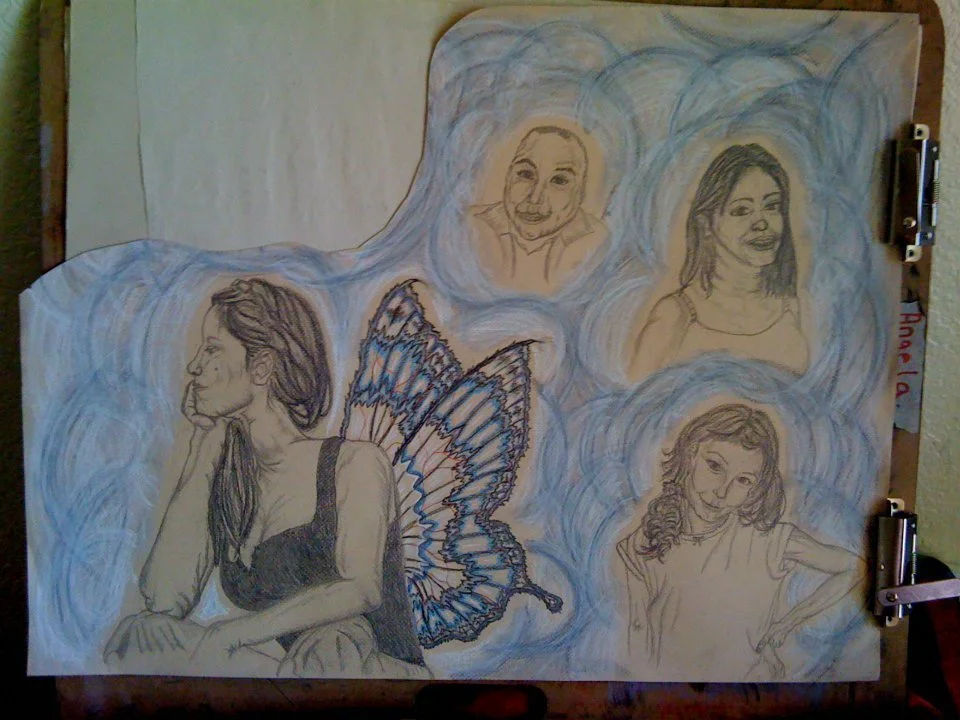 A drawing on paper features a young woman with long hair and butterfly wings, surrounded by four floating portraits, each with different hairstyles and expressions, against a background with blue swirls.