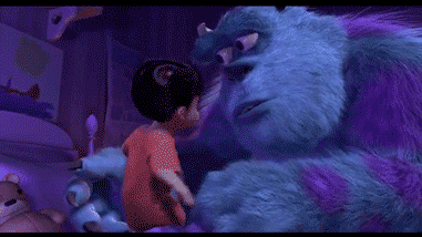 A GIF of a young girl talking to a large blue, furry monster in a dimly lit room, animated style from Monsters INC.