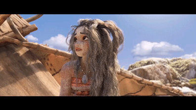 A GIF of an Animated Moana with long, messy gray hair, large eyes, and a curious expression standing outdoors near a wooden structure with rocks and blue sky in the background.
