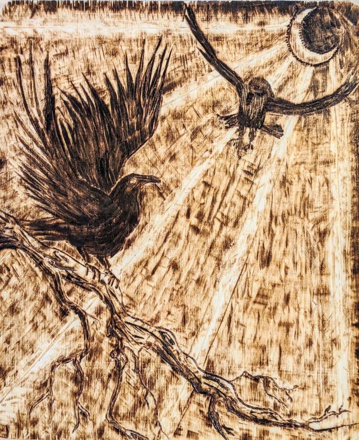 A woodburned artwork depicting two birds in flight, one perched on a branch, with the sun shining in the background.