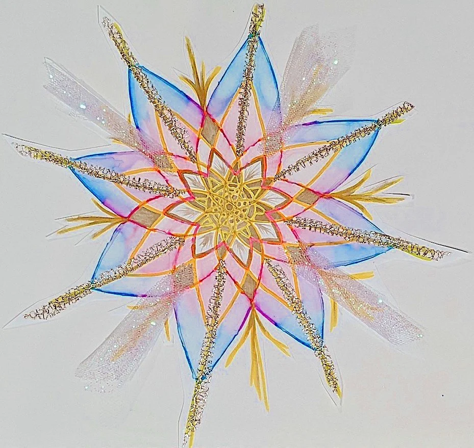 Colorful, intricate paper snowflake with layered patterns and vibrant colors, including blue, pink, yellow, and gold.