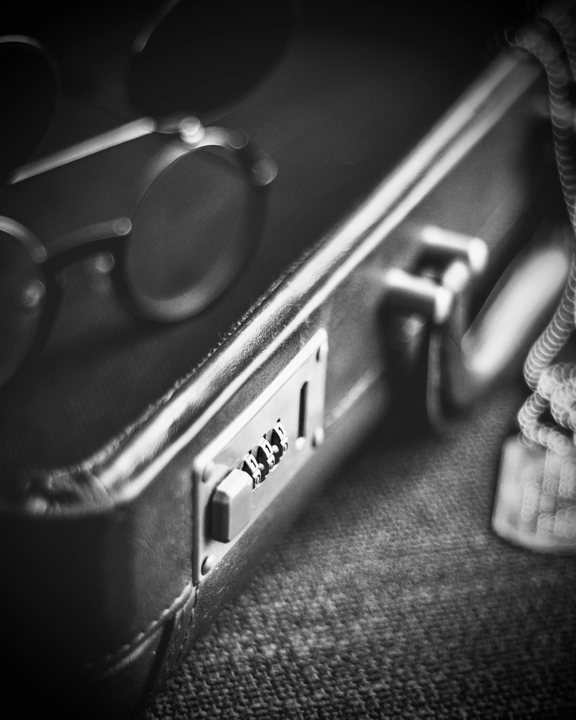 Close up lack and white photo of the locking mechanism of an attache case.