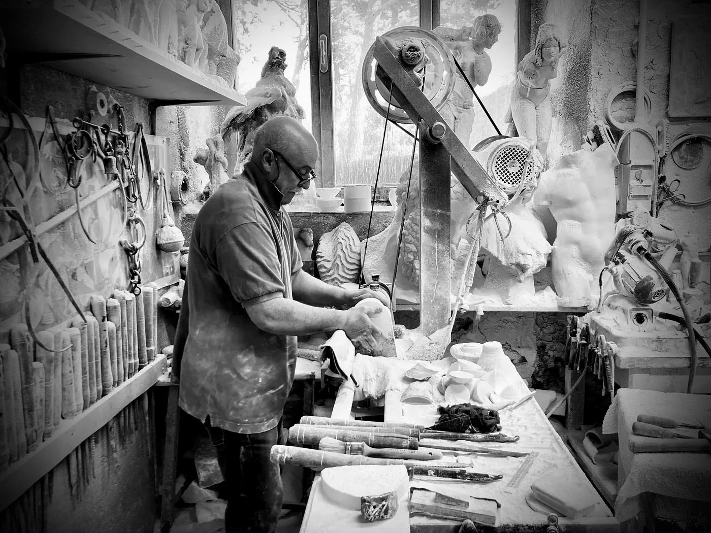 Photo of an alabaster sculptor in his studio in Volterra, Italy.