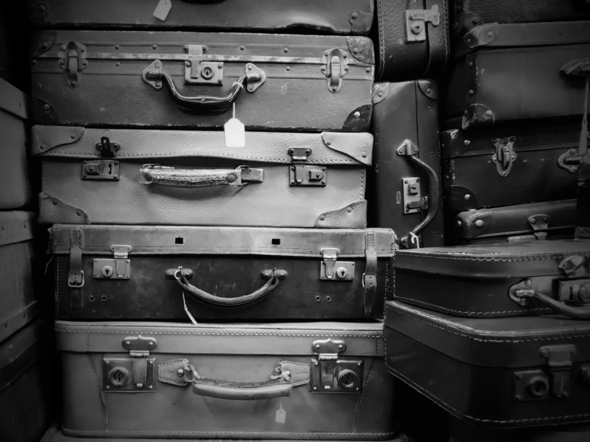 Black and white photo of stacked attache cases.