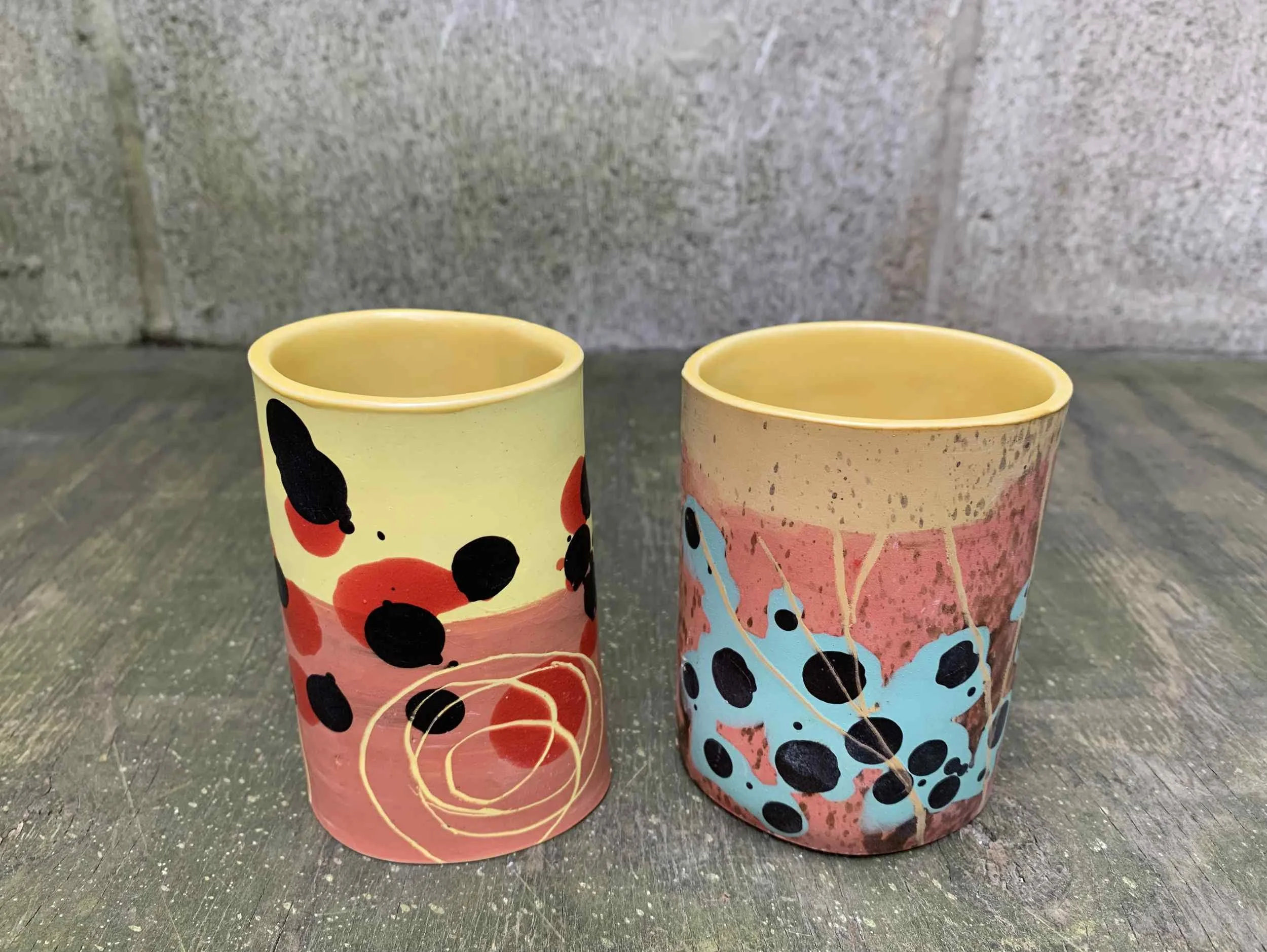 Coloured Cups 1, 2. Slipcast porcelain. Left: 7cm W x 10.5cm H x 5cm D, Right:7.5cm W x 9.5cm H x 7cm D.