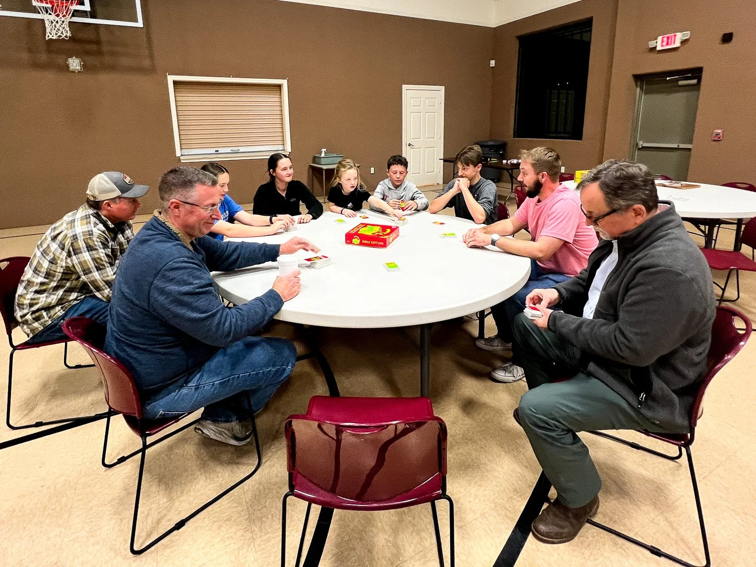 Group around a table playing Apples to Apples game