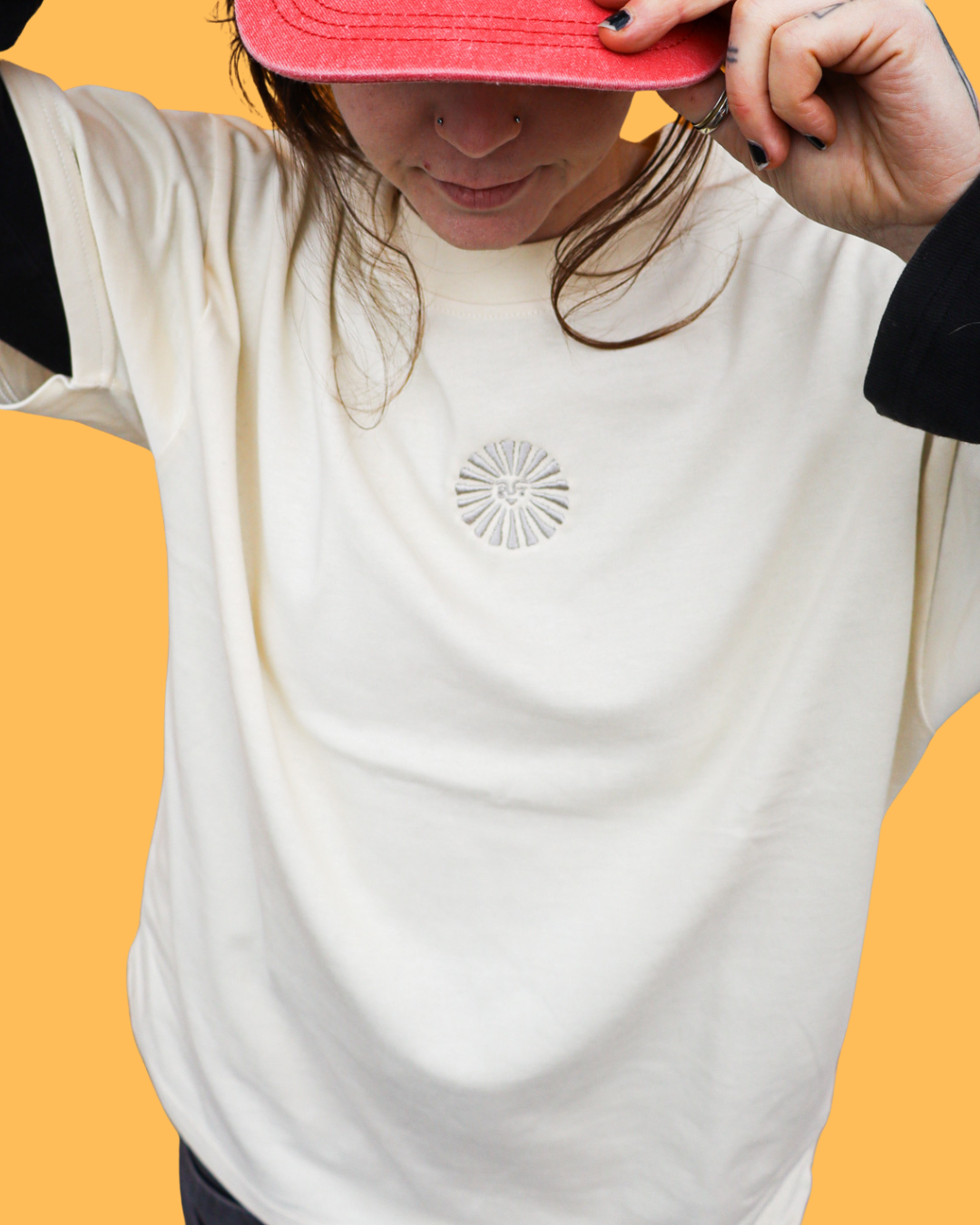 A woman wearing an Empire t-shirt and an Empire hat