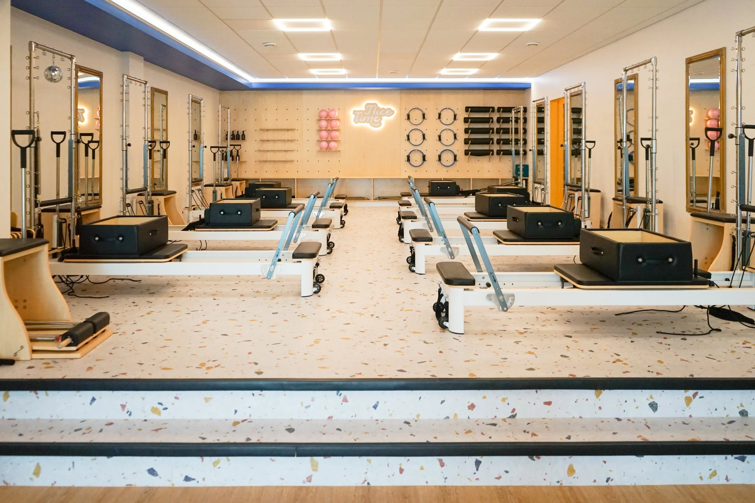 Nice time pilates studio floor with reformers, towers, chairs and mats