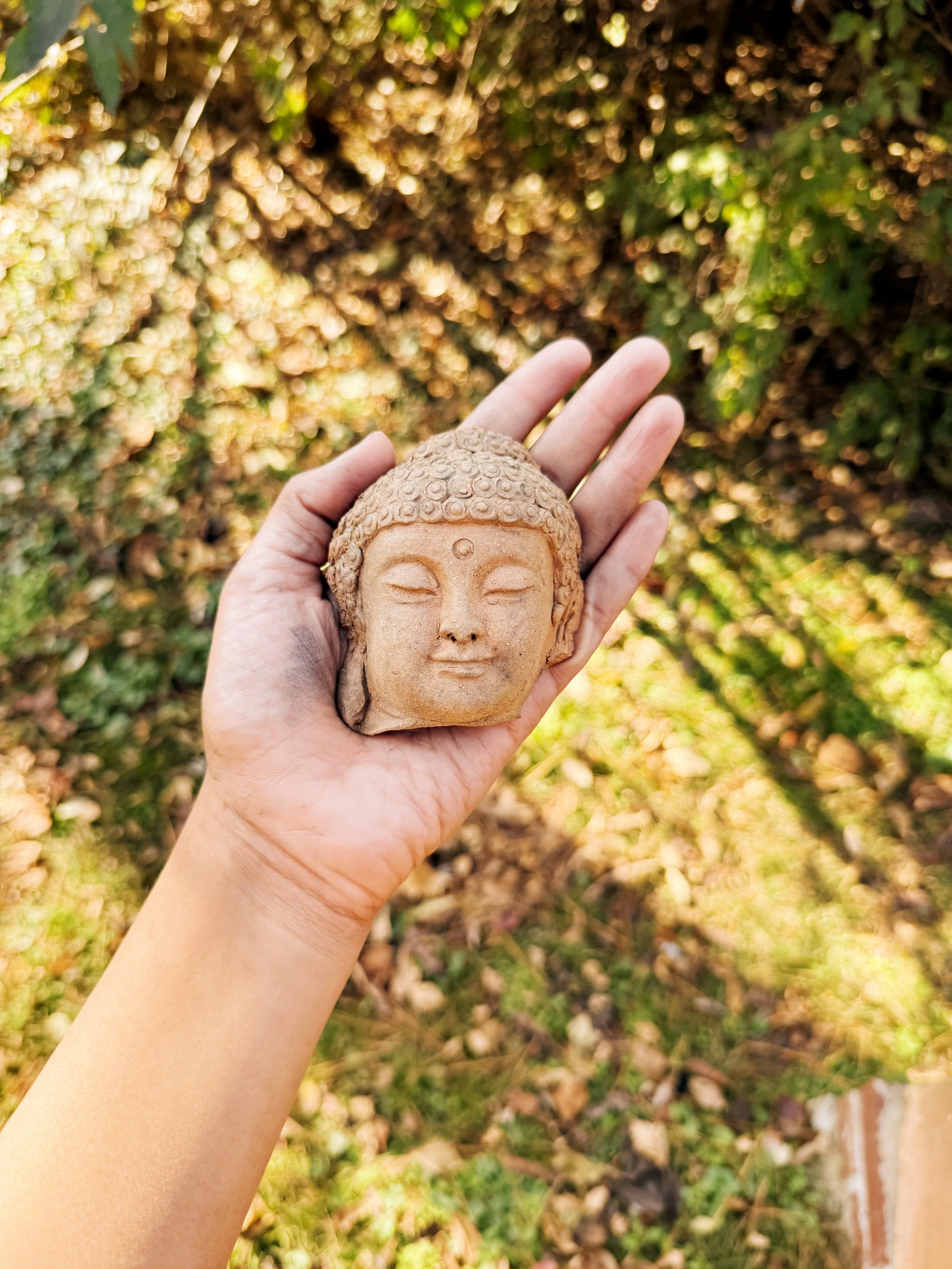november-woodfiring-sunlit-hand-clay-buddha.JPG