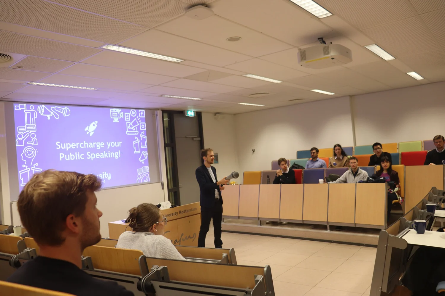 A trainer teaching in a lecture hall