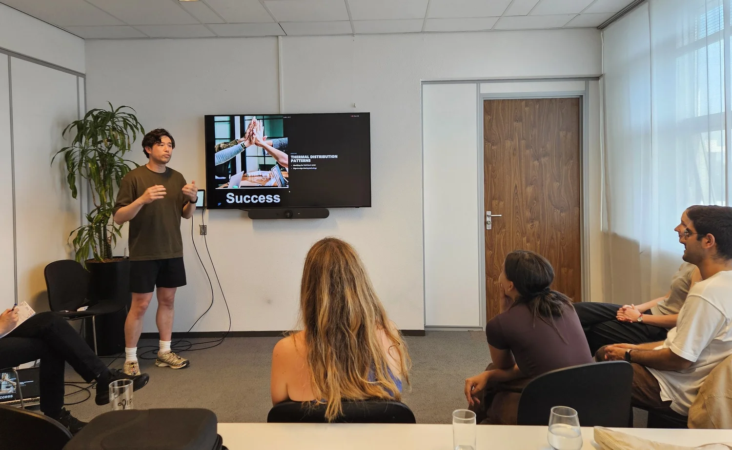 A participant presenting a slide to a small group